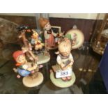 A collection of Hummel figurines to include boy on fence, teacher, etc