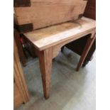A Victorian pine kitchen table on square tapering supports