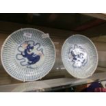 A pair of 19th century Chinese plates decorated with foodogsCracks to both plates. Chip to rim of