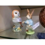 A Beswick model of an owl together with a Beswick model of Peter Rabbit