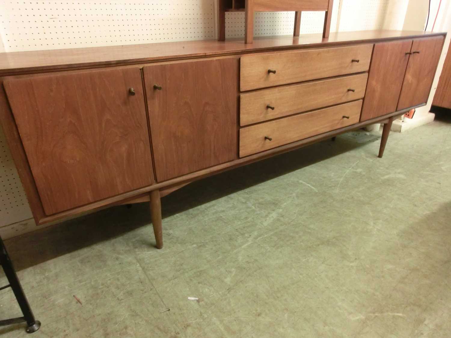 A mid-20th century teak sideboard by EverestMinor knocks and scratches throughout. No apparent major