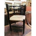 A child's 19th century stained beech and rush seat corner chair