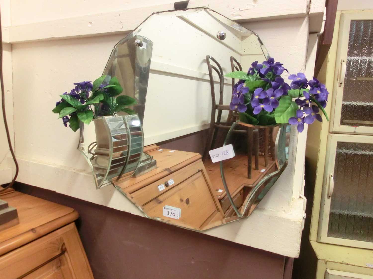 A mid-20th century frameless mirror with attached planters