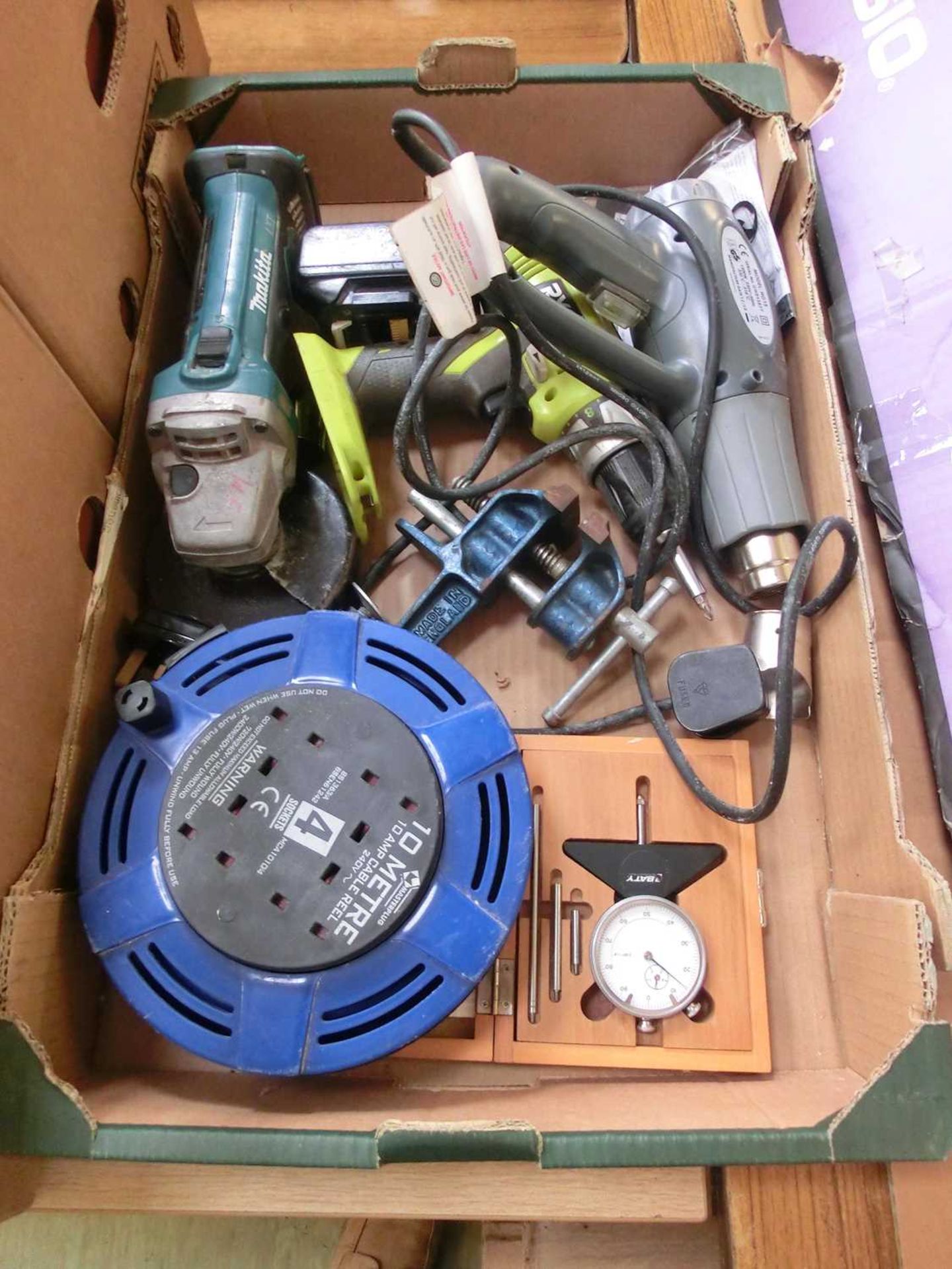A tray containing power tools, extension cable, vice etc.