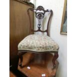 A late 19th century mahogany framed bedroom chair with carved and pierced splat over serpentine