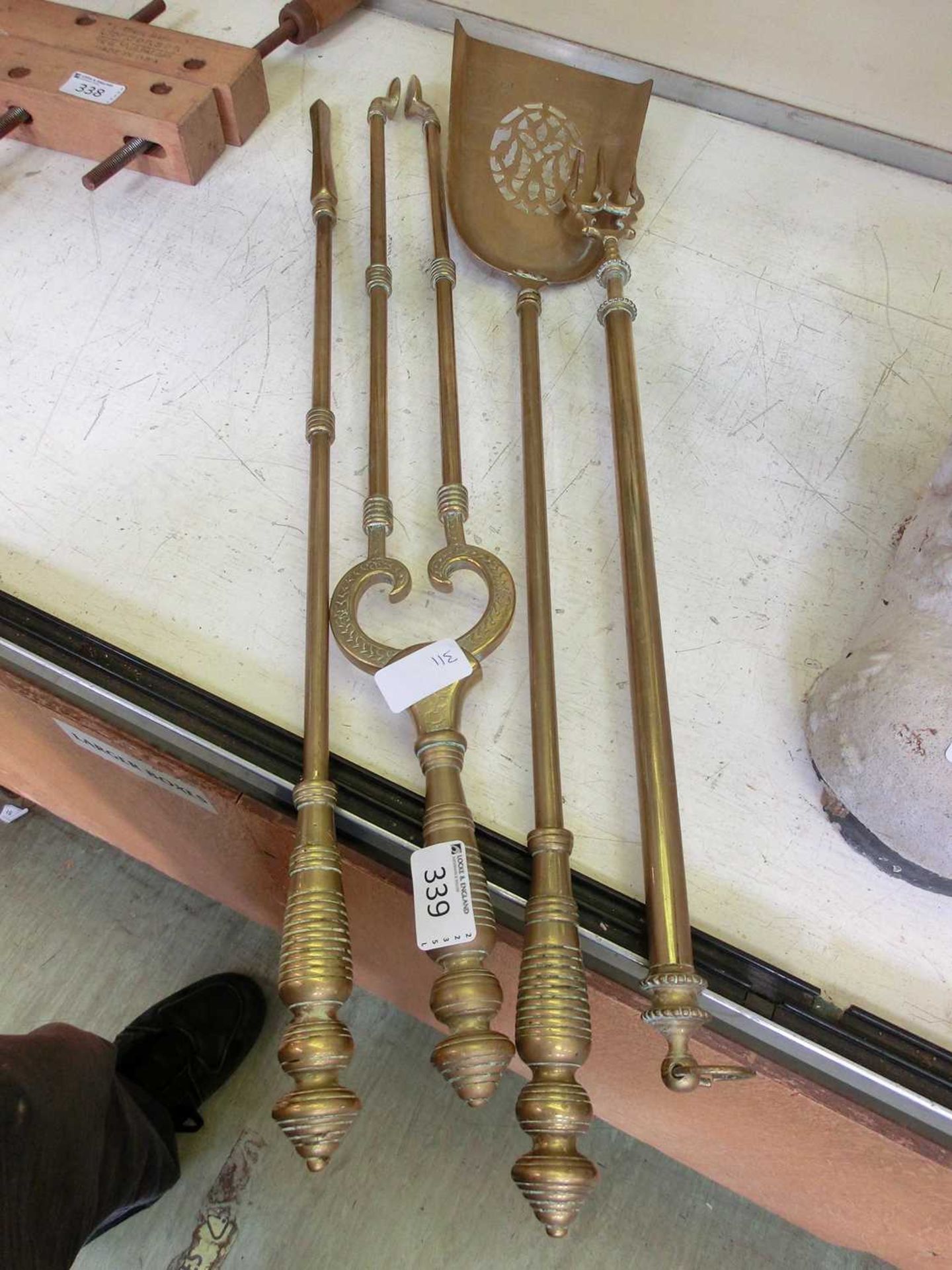 A brass fireside companion set comprising of tongs, fork, shovel etc.