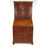 An 18th century oak bureau bookcase, the dental cornice over the two panel doors with reeded