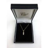 An 18ct gold and three stone diamond pendant on a fine 9ct gold chain. Approx. weight 2.5g