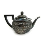 A Victorian silver bachelors teapot, the body with embossed reeded decoration and flowers.