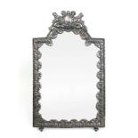 A late 19th/early 20th century silver plated easel mirror with encroaching floral border and torch