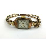 A ladies yellow metal Bernex mechanical wristwatch on a 9ct gold strap. Approx weight 14g