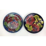 A Moorcroft Clematis pattern plate together with a Hibiscus pattern plate, dia. 26 cm