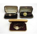 A ladies 9ct gold Buren watch together with two other ladies yellow metal watches.