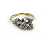 An 18ct gold and diamond crossover ring, the three stones in a heart shaped setting. Approx weight