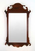 A Georgian mahogany fretwork mirror, h.60 cm, w. 35 cmLater plate. Condition commensurate with age.