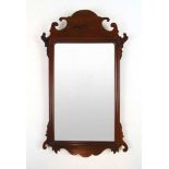 A Georgian mahogany fretwork mirror, h.60 cm, w. 35 cmLater plate. Condition commensurate with age.