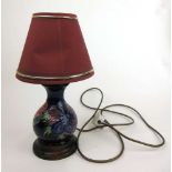 A Moorcroft Anemone pattern lamp decorated on a dark blue ground, h. 35 cmHeight including shade