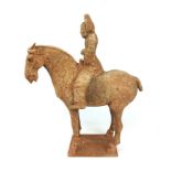 A Chinese pottery model of a horse and rider, probably Tang Dynasty, h. 43.5 cm