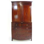 An Edwardian mahogany and parquetry strung bowfront linen press, the cornice over two panel cupboard