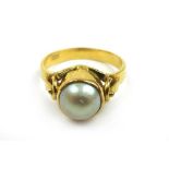 A yellow metal and pearl dress ring marked '916'. Approx. weight 4.8g. Size N 1/2