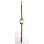 A ladies yellow metal Omega mechanical wristwatch on a 9ct gold strap. Approx. weight 14.3g