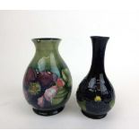 A Moorcroft Clematis pattern baluster vase decorated on a woodsmoke ground together with a Moorcroft