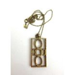 A 9ct gold modernist design pendant on chain. Approx weight 11g