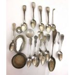 An assortment of silver and white metal items to include spoons, napkin ring, clothes brush etc.