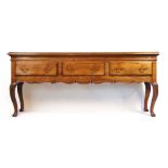 A 20th century 18th century style oak dresser base, the moulded top over three drawers and a