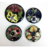 Four Moorcroft pot lids to include Berry pattern, max dia. 18 cm