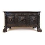 A 19th century carved oak coffer, the top lifting to reveal a vacant interior over the three panel