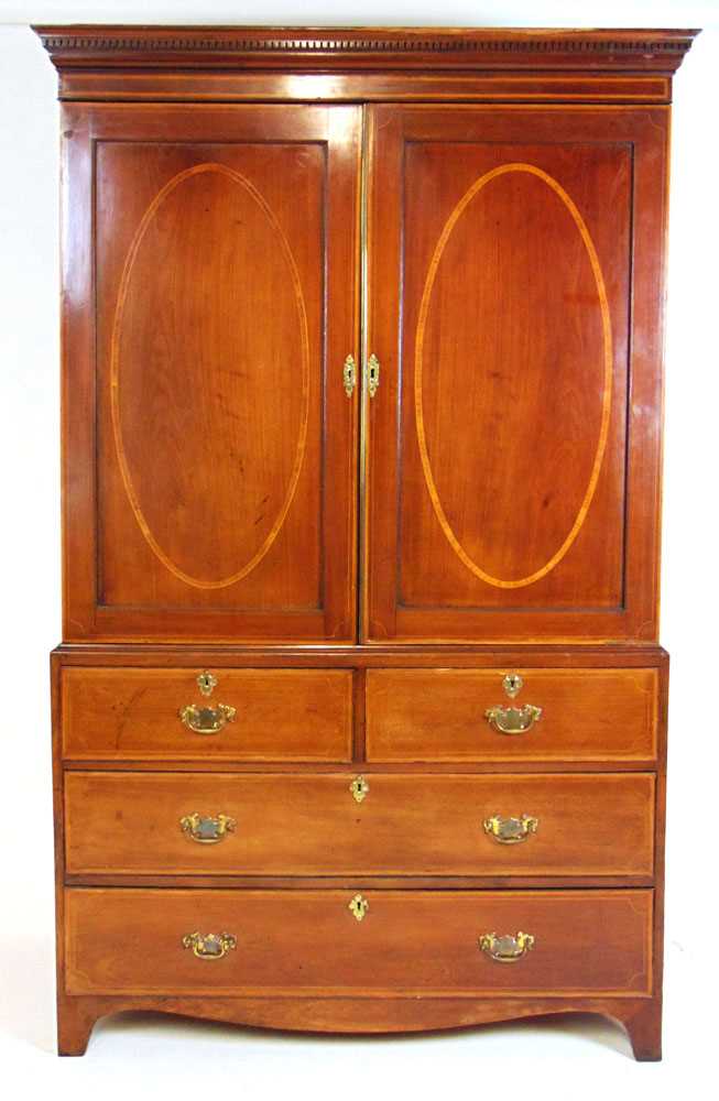 An Edwardian mahogany, satinwood banded and boxwood strung linen press, the dental cornice over