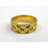 A 22ct gold patterned wedding band. Approx. weight 5.3g. Size K