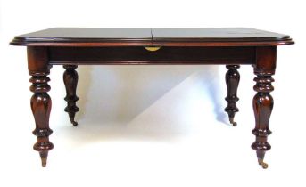 A reproduction 19th century style mahogany extending dining table, the moulded top with two extra