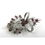 A white metal, ruby and diamond floral splay brooch marked '750'. Approx. weight 9.4g