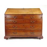 An 18th century mahogany bureau, the fall front with a fitted interior over two short and three