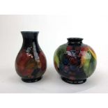 A Moorcroft Pomegranate pattern baluster vase together with a Moorcroft Berry pattern vase of