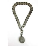 A Victorian white metal engraved locket on chain. Approx. weight 55.4g