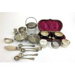 An assortment of silver items to include a cased salts set, bonbon dishes, napkin rings etc. Various