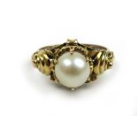 A yellow metal and pearl dress ring marked '14k'. Approx. weight 3.5g. Size M