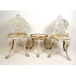 A 19th century cast iron garden set, comprising of a white painted pair of chairs and a table, h. 82