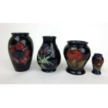 Four small Moorcroft blue ground vases to include Pomegranate, h. 10 cmPomegranate vase restored