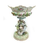 A 19th century Meissen style floral encrusted porcelain comport modelled with four figures to