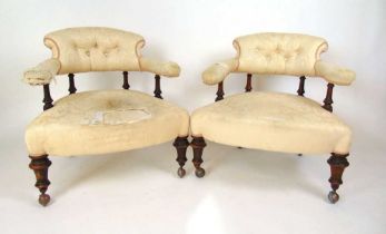 A pair of Victorian walnut spindle back tub chairs upholstered in a button back floral patterned