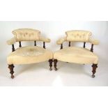 A pair of Victorian walnut spindle back tub chairs upholstered in a button back floral patterned