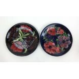 Two Moorcroft Anemone pattern plates decorated on blue grounds, dia. 26 cm