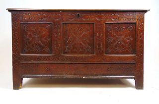 An 18th century oak mule chest, the top lifting to reveal a vacant interior with candle box over the