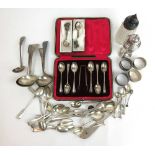 An assortment of silver and white metal items to include sugar caster, napkin rings, ladles, cased