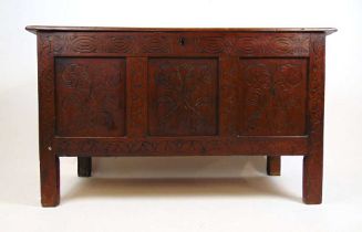 An 18th century and later oak coffer, the top lifting to reveal a vacant interior over the later
