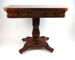 A early 19th century mahogany tea table, the fold over top supported on a swivel action on a